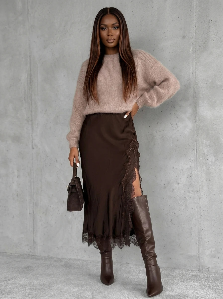 Woman wearing a chocolate brown viscose satin midi skirt with lace trim in a studio setting