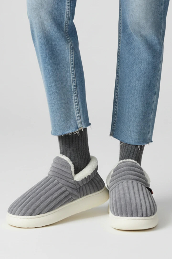 Woman wearing a grey ribbed upper faux fur lined slipper - lifestyle photo
