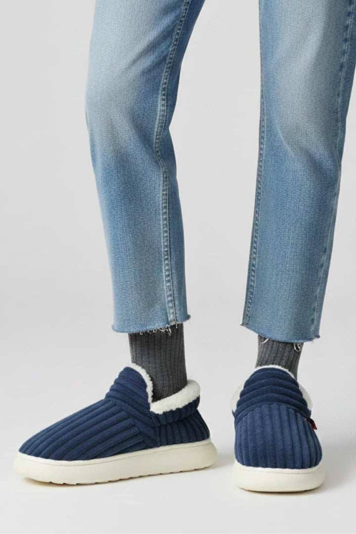 Woman wearing a navy ribbed upper faux fur lined slipper - lifestyle photo