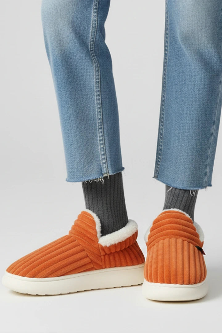 Woman wearing a orange ribbed upper faux fur lined slipper - lifestyle photo
