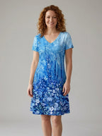 Driftly women's blue and white floral 3D print V-neck A-line sundress, in a minimalist studio setting.