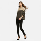 Woman wearing apricot and black colorblock wool turtleneck knit sweater