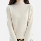Woman wearing a beige wool half-neck sweater in a studio setting
