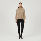Beige oversized turtleneck sweater with dropped shoulders, front view