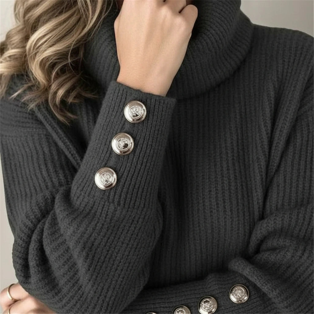 Close-up of black sweater cuff with decorative buttons