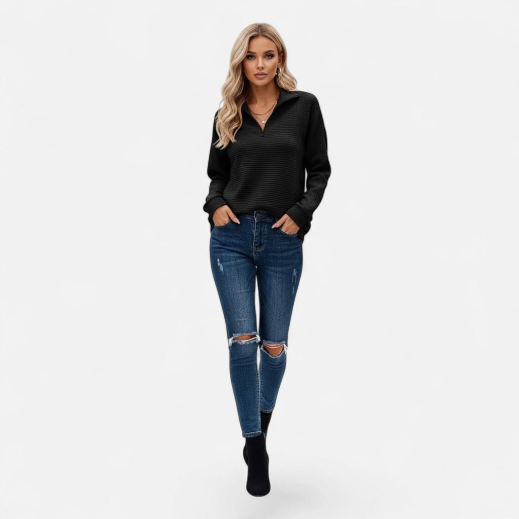 Woman wearing black zipper stand-collar ribbed knit sweater