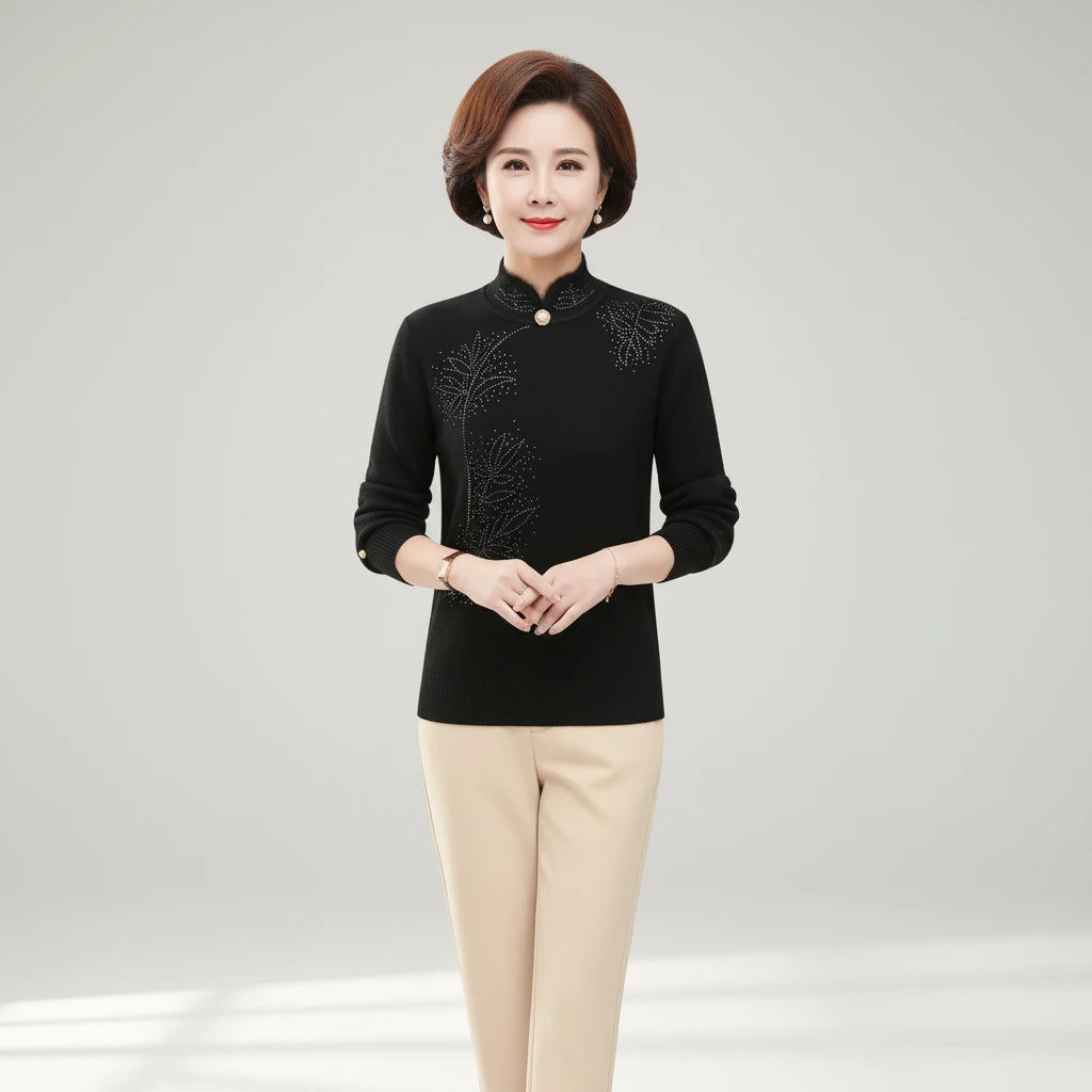 Woman wearing black high-collar sweater with printed button detail, front view