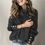 Woman wearing black ribbed cowl neck sweater with button cuffs, front view