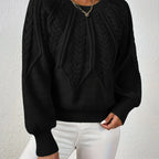 Woman wearing a black voluminous sleeve sweater with cable knit texture