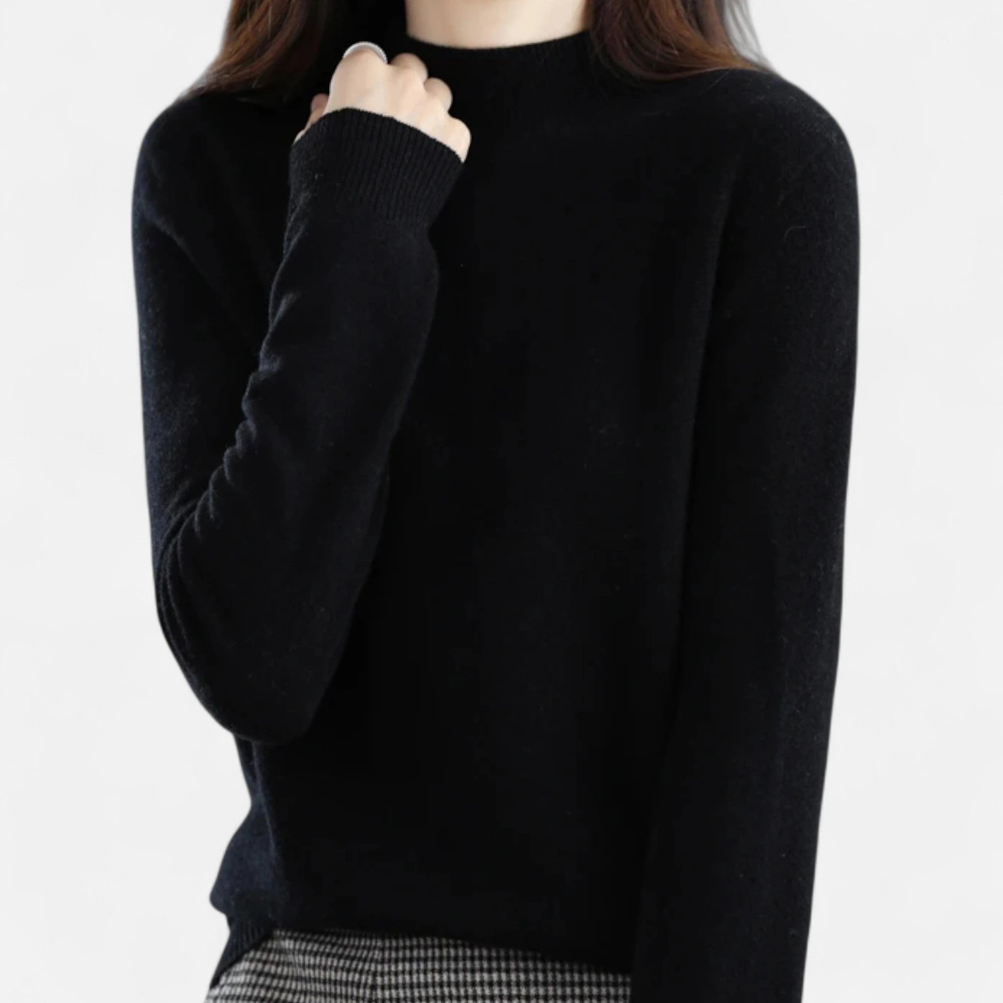 Woman wearing a black wool half-neck sweater in a studio setting