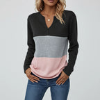 Woman wearing black panelled V-neck sweater, studio photo