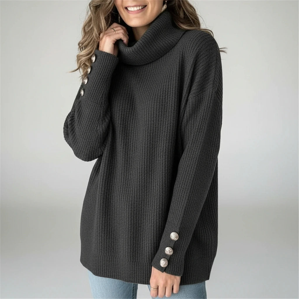 Woman wearing black ribbed cowl neck sweater with button cuffs, studio photo