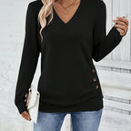 Woman wearing black V-neck sweater with side button detail, studio photo