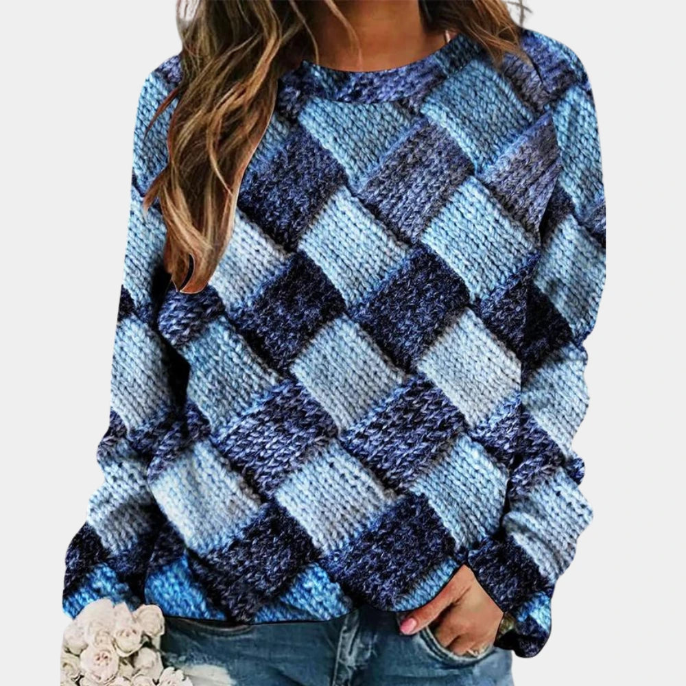 Woman wearing a blue colorblock diamond knit sweater with long sleeves