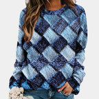 Woman wearing a blue colorblock diamond knit sweater with long sleeves