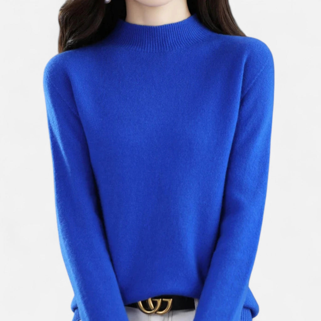 Woman wearing a blue wool half-neck sweater in a studio setting