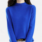 Woman wearing a blue wool half-neck sweater in a studio setting