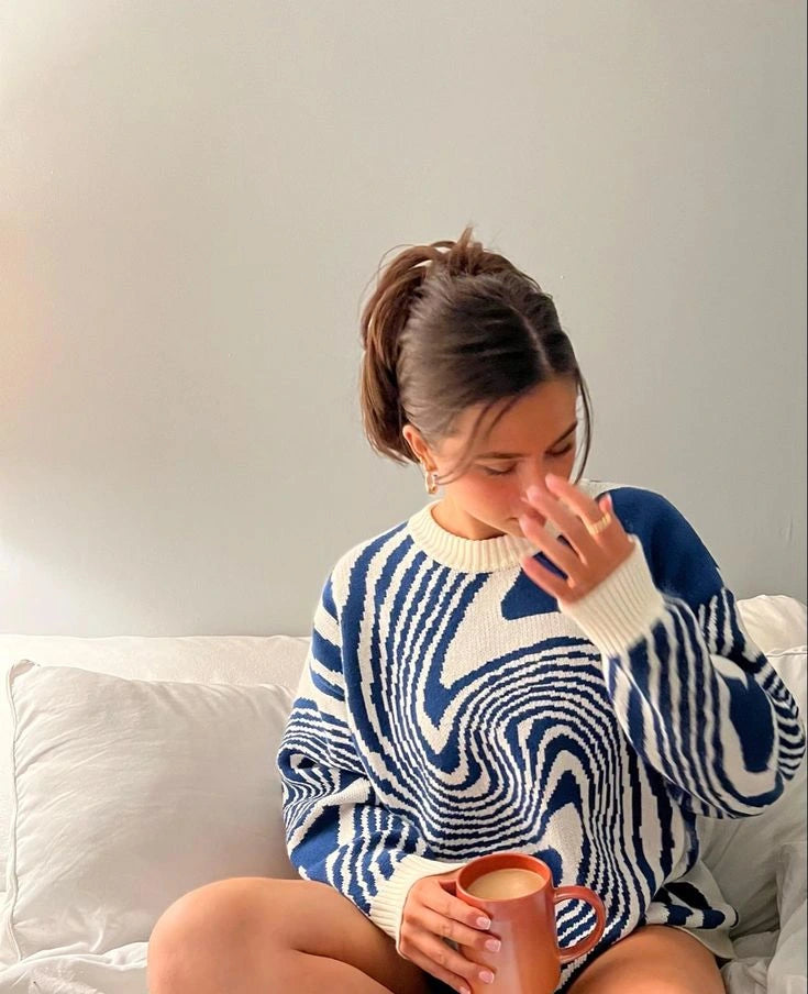 Woman wearing Driftly navy and white swirl pattern knitted pullover