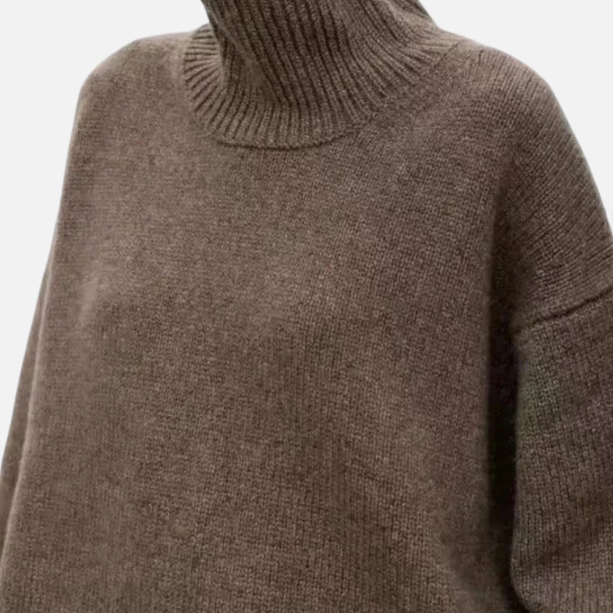 Woman wearing a brown oversized wool turtleneck sweater in a studio setting