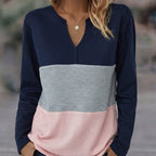 Close-up of dark blue panelled V-neck sweater neckline