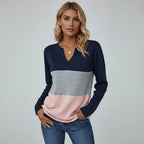 Woman wearing dark blue panelled V-neck sweater, studio photo