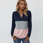 Woman wearing dark blue panelled V-neck sweater, front view