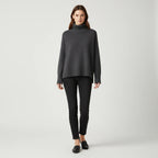 Dark grey oversized turtleneck sweater with dropped shoulders, front view