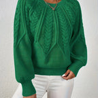 Woman wearing a green voluminous sleeve sweater with cable knit texture