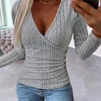Close-up of grey ribbed wrap sweater with side button detail