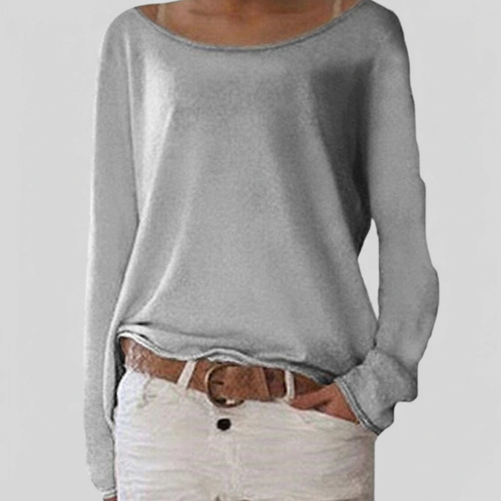 Woman wearing a grey lightweight boat neck sweater with relaxed draped fit