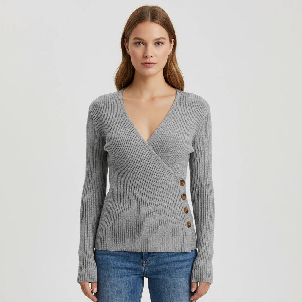 Woman wearing grey ribbed wrap sweater with side button detail, studio photo