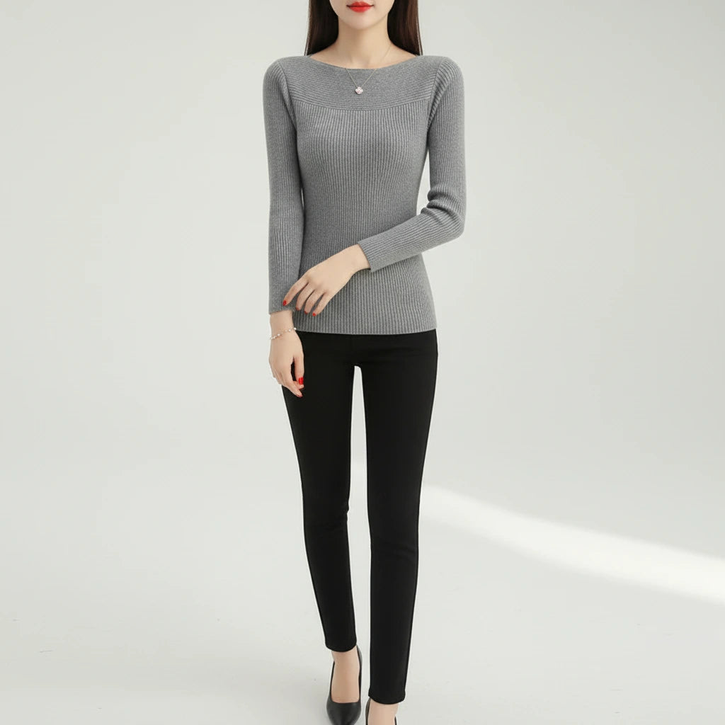 Woman wearing grey ribbed boat neck sweater, studio photo