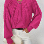 Woman wearing a hot pink voluminous sleeve sweater with cable knit texture
