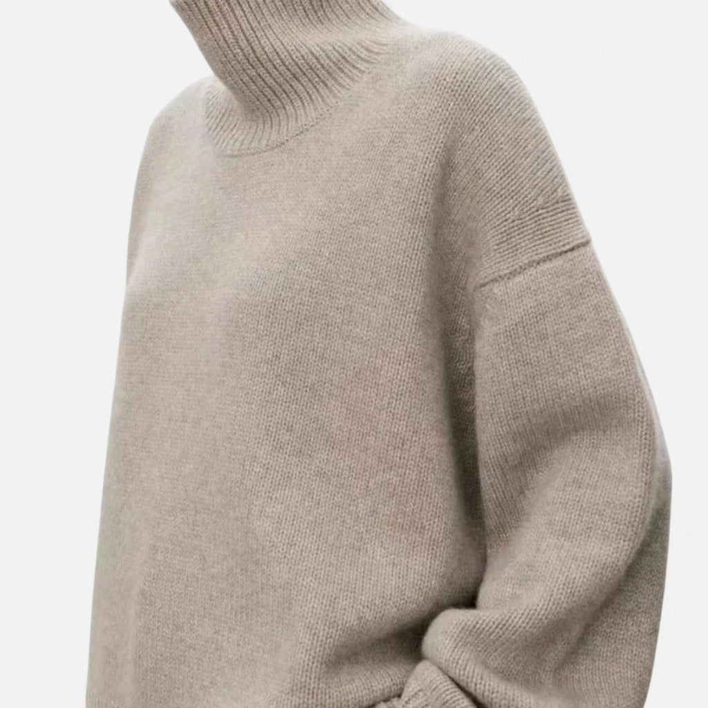 Woman wearing a khaki oversized wool turtleneck sweater in a studio setting