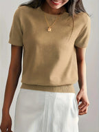 Woman wearing a khaki fine knit sweater with short sleeves, side view