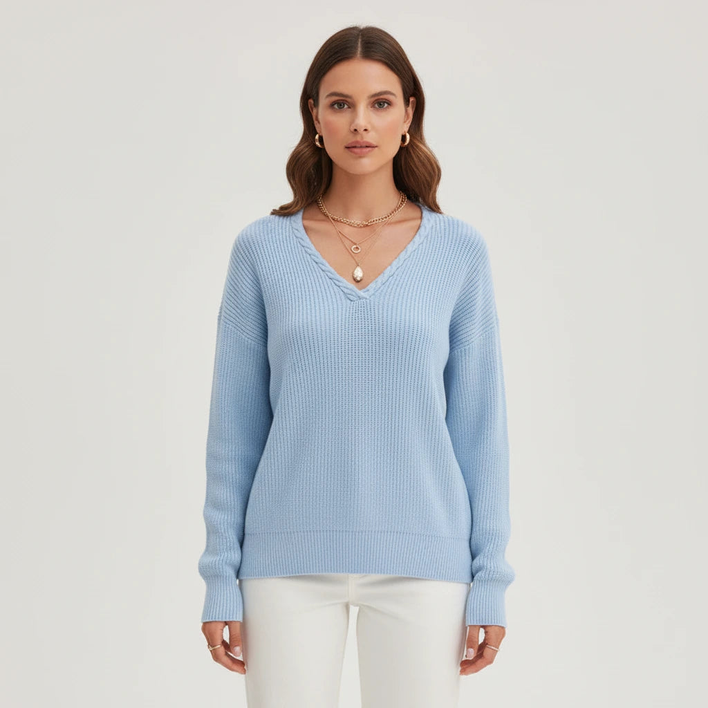 Woman wearing light blue ribbed V-neck sweater, front view