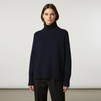 Navy blue oversized turtleneck sweater with dropped shoulders, front view
