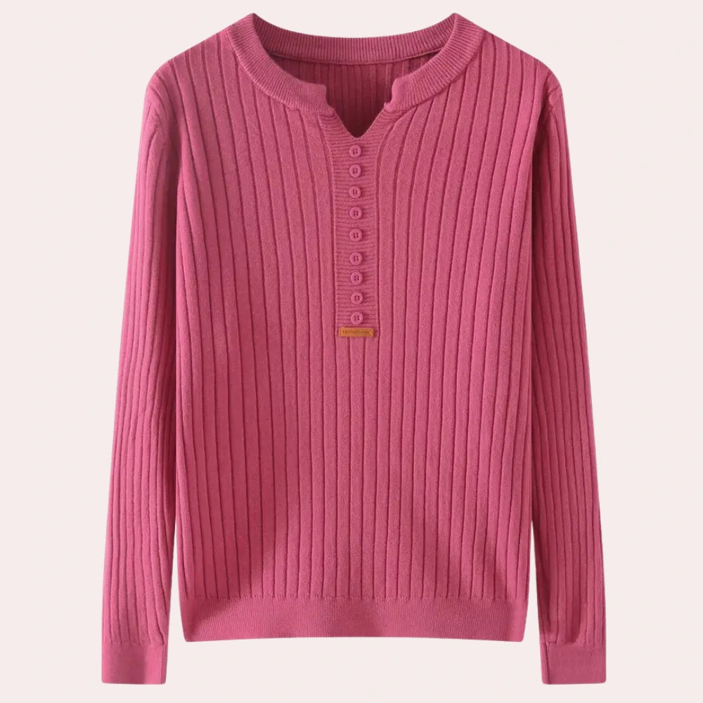 Pink ribbed knit sweater with notched neck and button placket, flat lay
