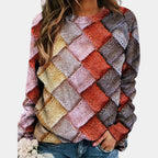 Woman wearing a pink colorblock diamond knit sweater with long sleeves
