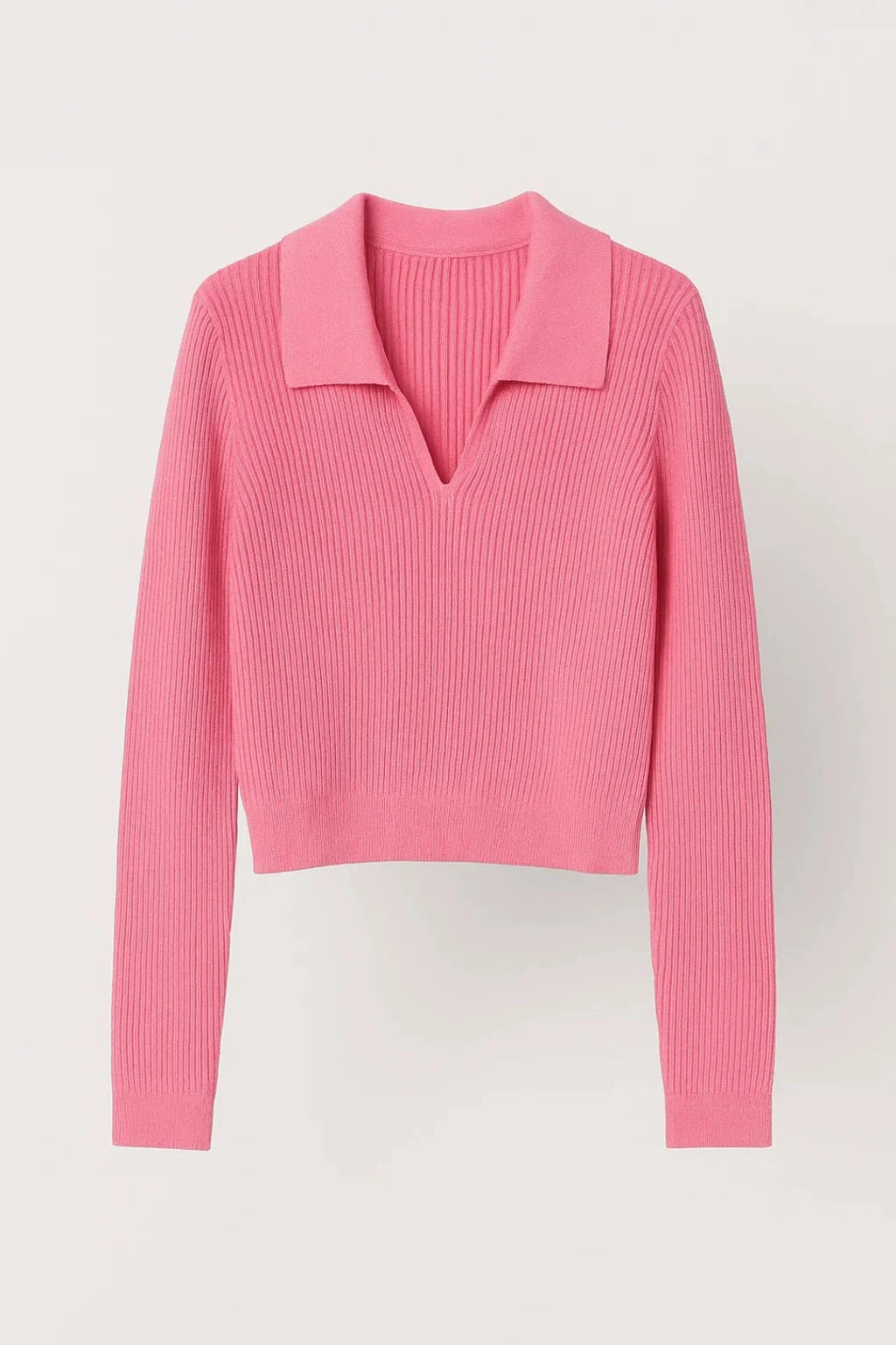 Woman wearing pink ribbed cropped V-neck sweater with collar