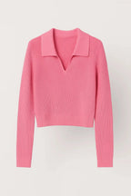 Woman wearing pink ribbed cropped V-neck sweater with collar