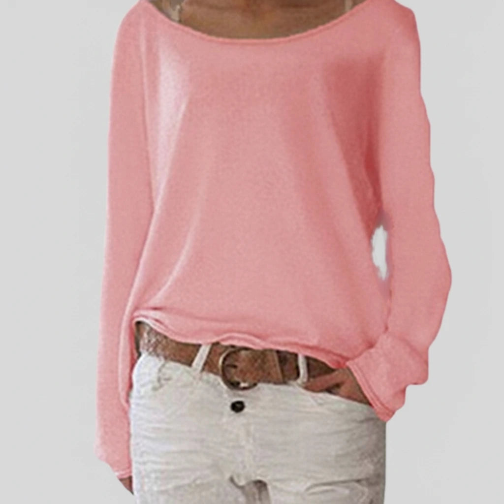 Woman wearing a pink lightweight boat neck sweater with relaxed draped fit