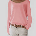 Woman wearing a pink lightweight boat neck sweater with relaxed draped fit