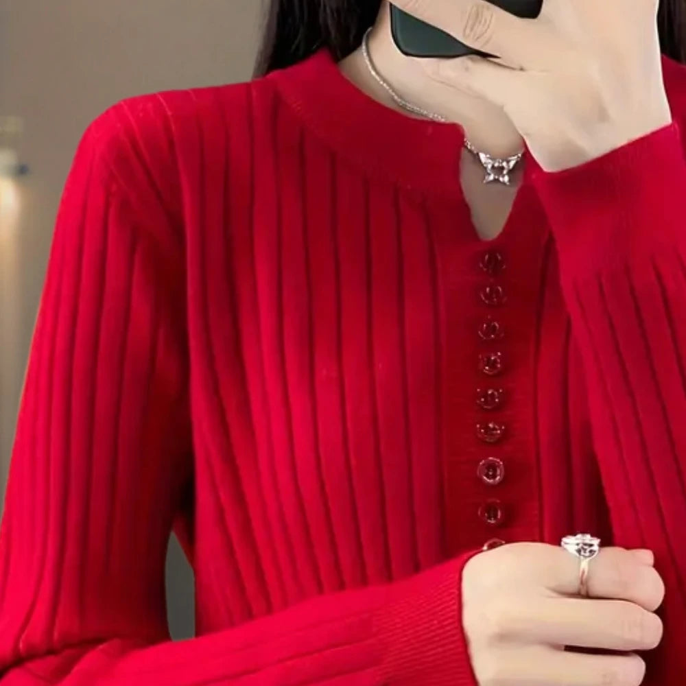 Close-up of woman wearing red ribbed knit sweater with button placket detail