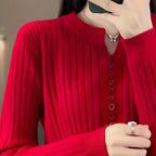 Close-up of woman wearing red ribbed knit sweater with button placket detail