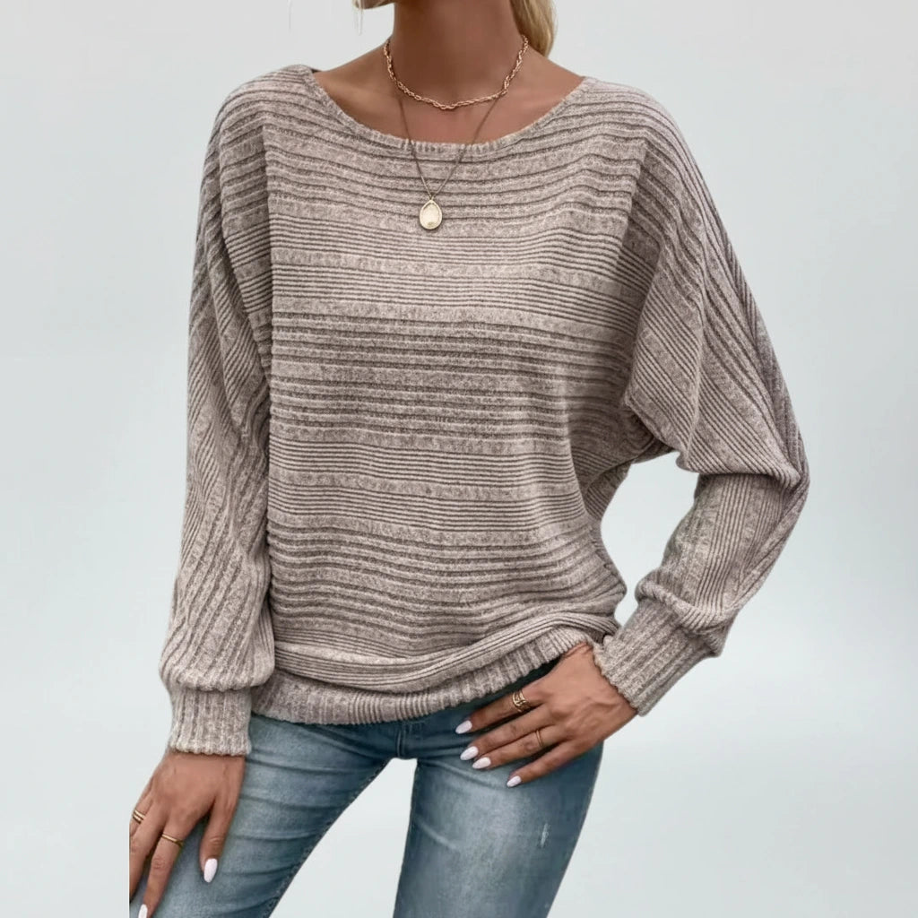 Woman wearing taupe textured knit sweater with batwing sleeves, front view