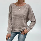 Woman wearing taupe textured knit sweater with batwing sleeves, front view