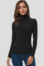 Woman wearing a black turtleneck long sleeve plain sweater - studio photo