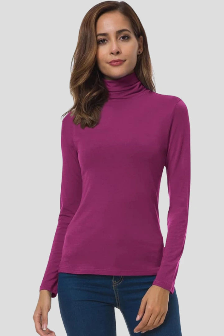 Woman wearing a fuchsia turtleneck long sleeve plain sweater - studio photo