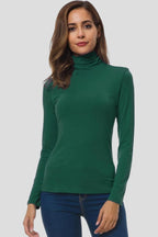 Woman wearing a green turtleneck long sleeve plain sweater - studio photo